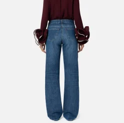 Jeans a gamba larga in cotone organico con bande in raso