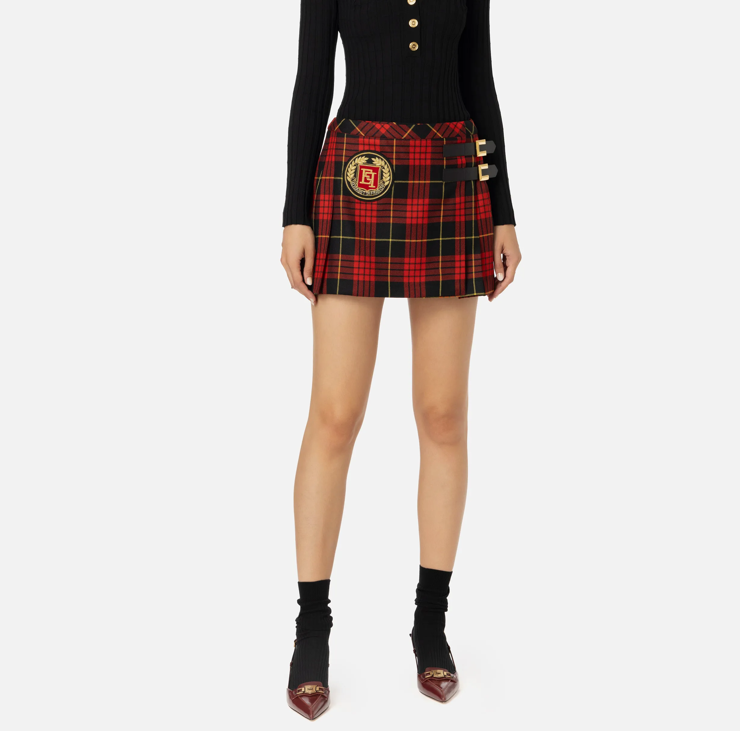 Minigonna a pieghe in lana tartan con patch ricamato