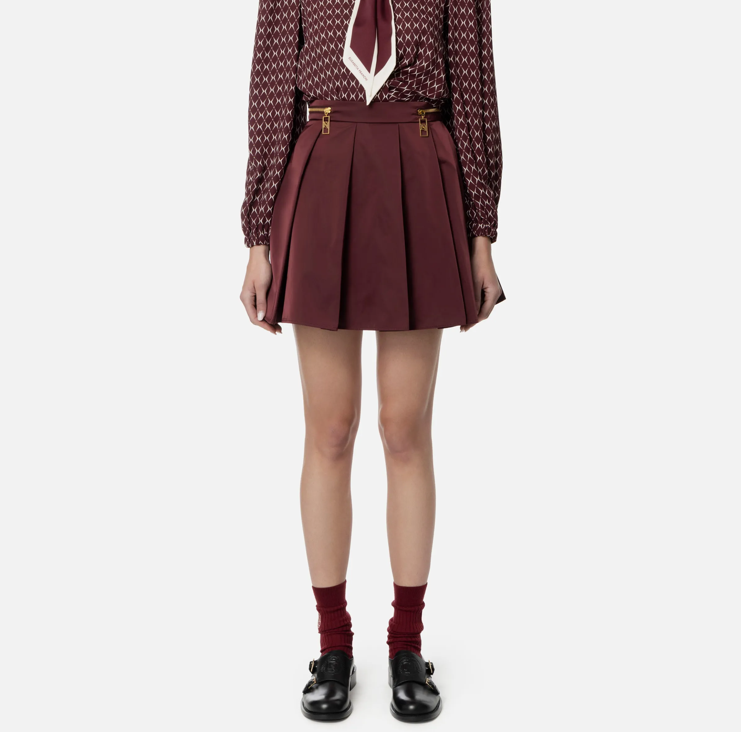 Minigonna a pieghe in nylon tecnico con zip