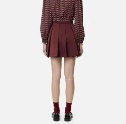 Minigonna a pieghe in nylon tecnico con zip
