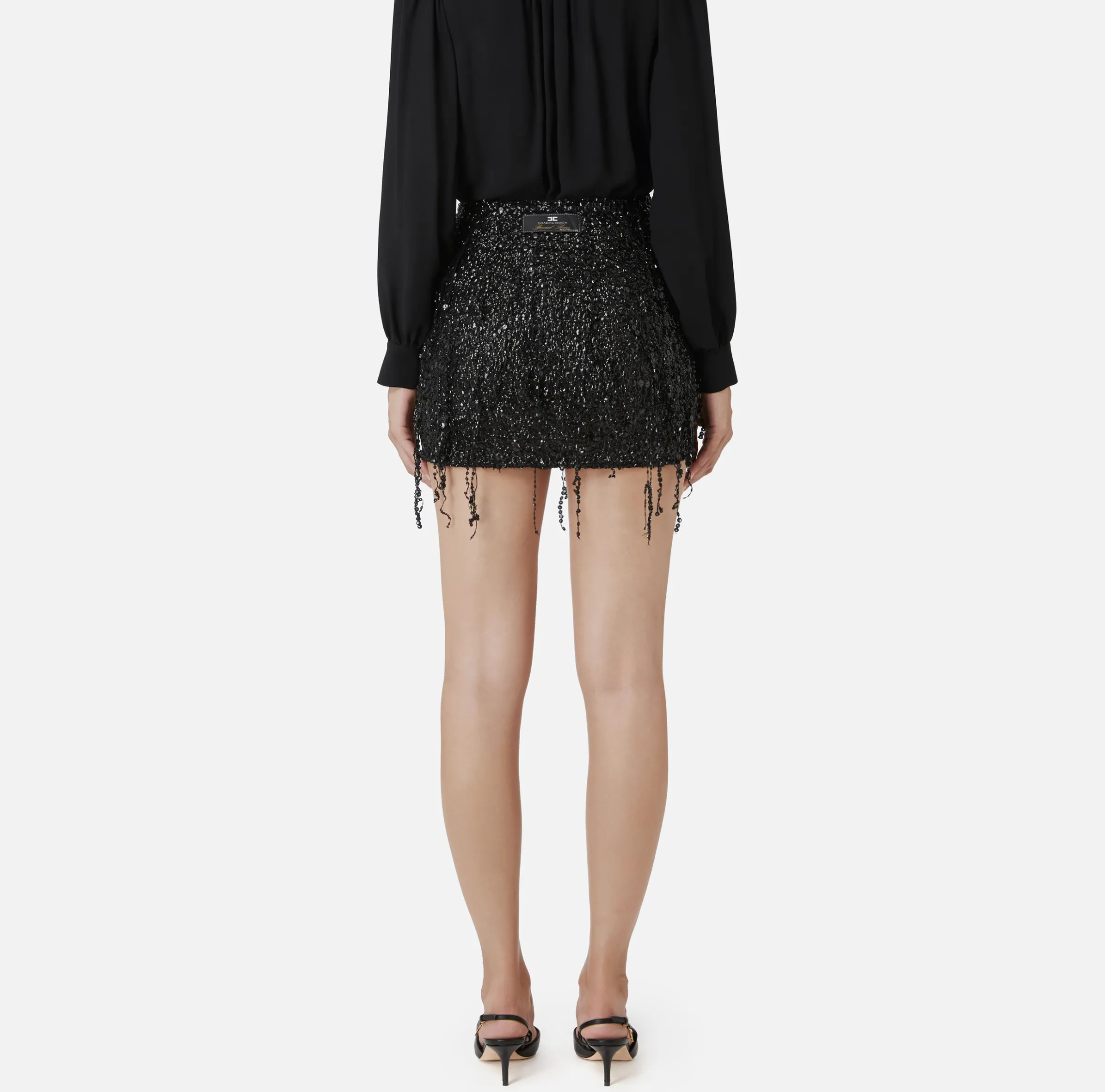 Minigonna in tulle ricamata con frange di paillettes