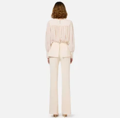 Tuta in crêpe con blusa in georgette e baschina